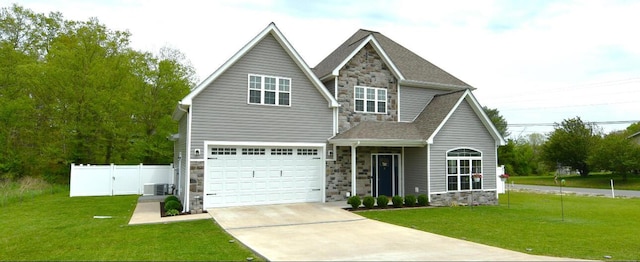 view of front of house featuring central AC, a front yard, and a garage