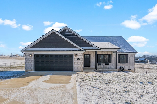 view of front of home with an attached garage, fence, concrete driveway, and brick siding