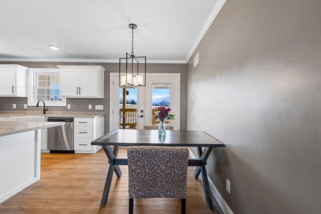 kitchen with stainless steel appliances, white cabinetry, crown molding, and custom exhaust hood