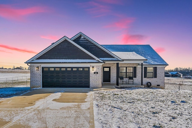 view of front facade with brick siding, an attached garage, crawl space, fence, and driveway