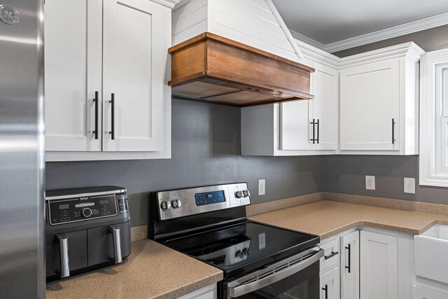 kitchen featuring dishwashing machine, a sink, and white cabinetry