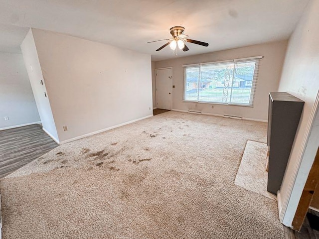 carpeted empty room featuring ceiling fan