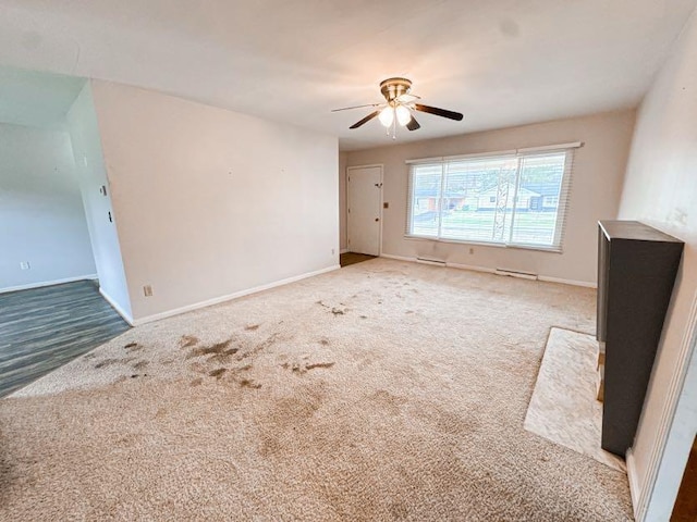 empty room with carpet and ceiling fan