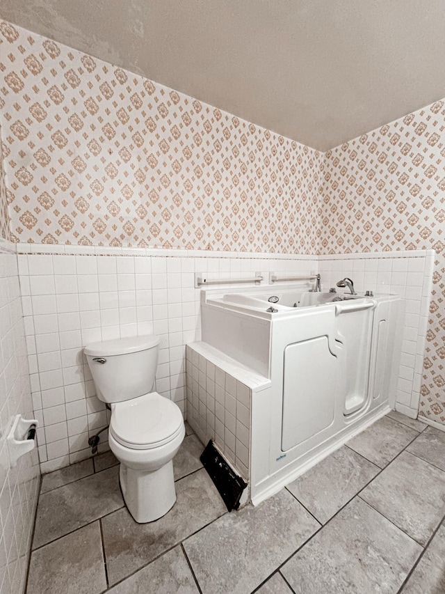 bathroom featuring tile patterned floors and toilet