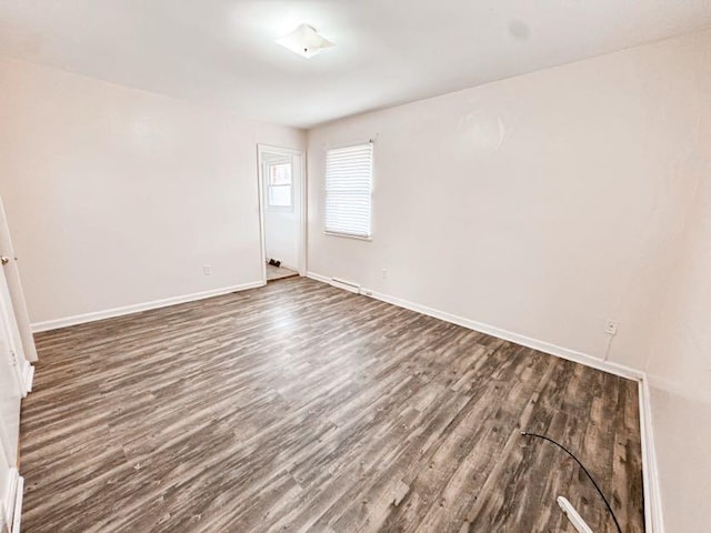 spare room with dark hardwood / wood-style flooring