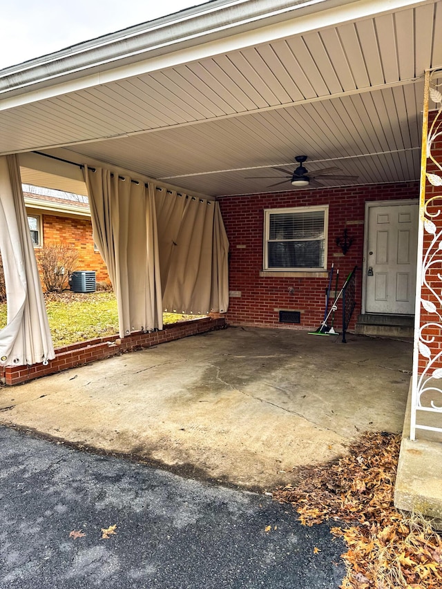 view of patio / terrace featuring central AC unit, ceiling fan, and a carport