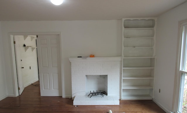 unfurnished living room featuring dark hardwood / wood-style flooring and a fireplace