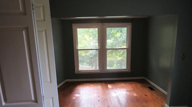 unfurnished room with light hardwood / wood-style flooring