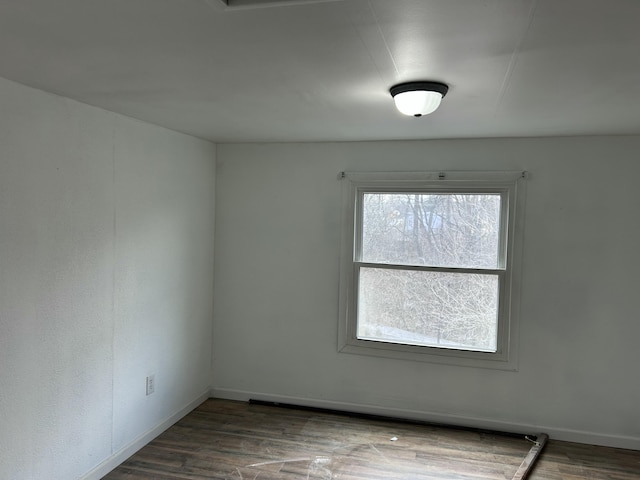 spare room featuring dark hardwood / wood-style floors