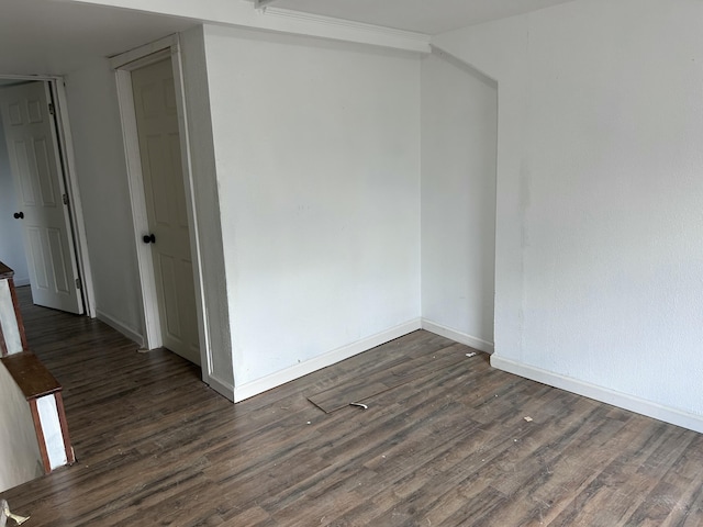 spare room with dark hardwood / wood-style floors