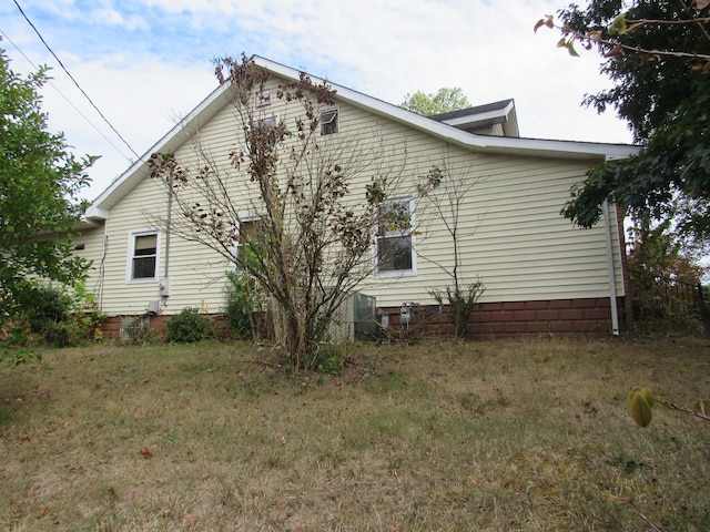 view of home's exterior with a lawn