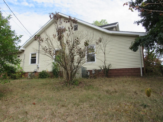 view of side of property with a lawn