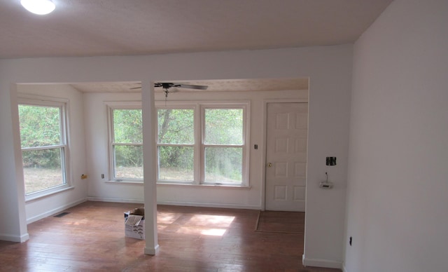 unfurnished room featuring hardwood / wood-style floors, plenty of natural light, and ceiling fan