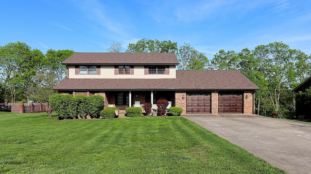 920 Meadow Ln, Harrodsburg, KY 40330 - traditional home featuring a front lawn, a garage, driveway, brick siding, and fence