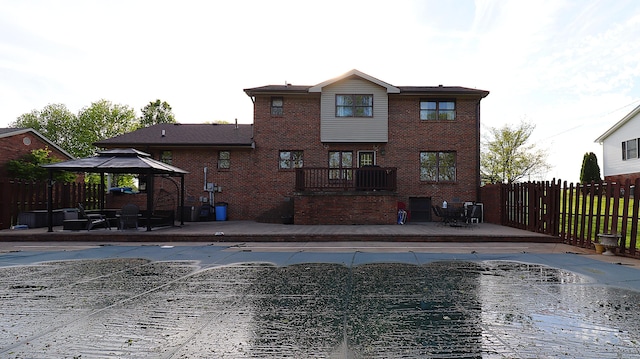 920 Meadow Ln, Harrodsburg, KY 40330 - rear view of house featuring brick siding, a wooden deck, a gazebo, and fence