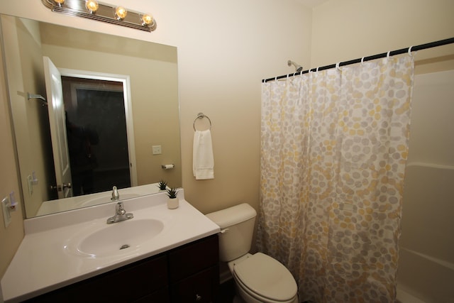 bathroom featuring vanity, toilet, and a shower with shower curtain