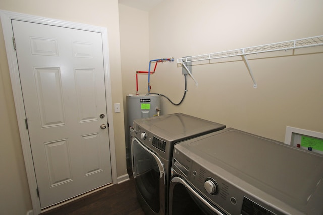 laundry room with dark hardwood / wood-style floors, water heater, and washing machine and clothes dryer