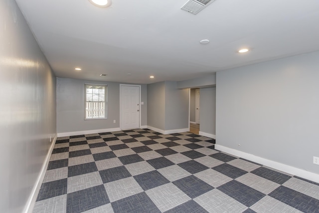 spare room with recessed lighting, visible vents, baseboards, and dark colored carpet