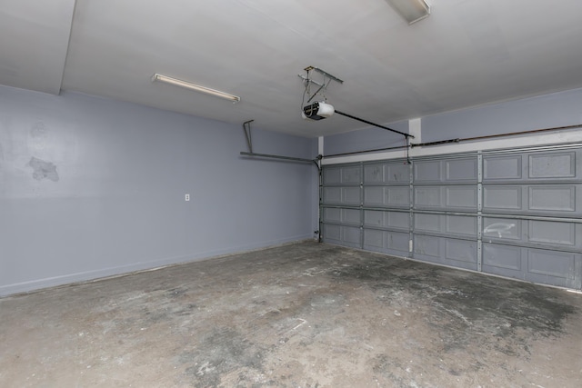 garage featuring baseboards and a garage door opener