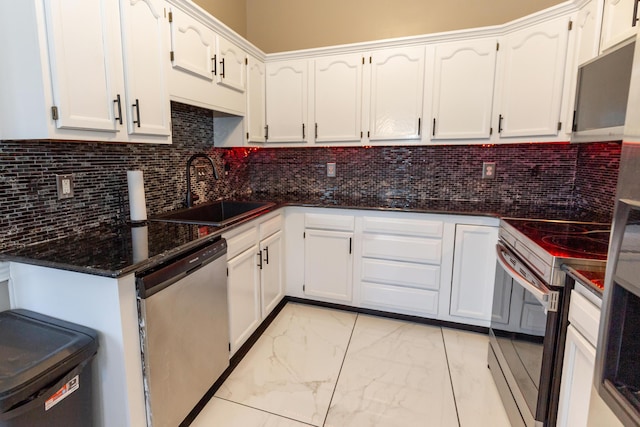 kitchen featuring marble finish floor, stainless steel appliances, a sink, and white cabinetry