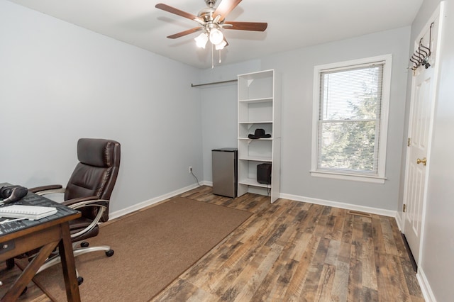 office featuring a ceiling fan, baseboards, and wood finished floors