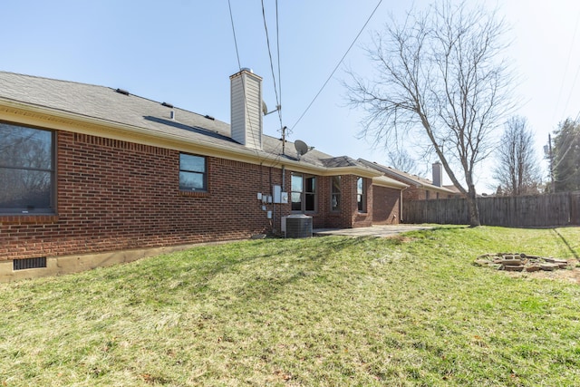 view of yard featuring fence, central AC, and a patio