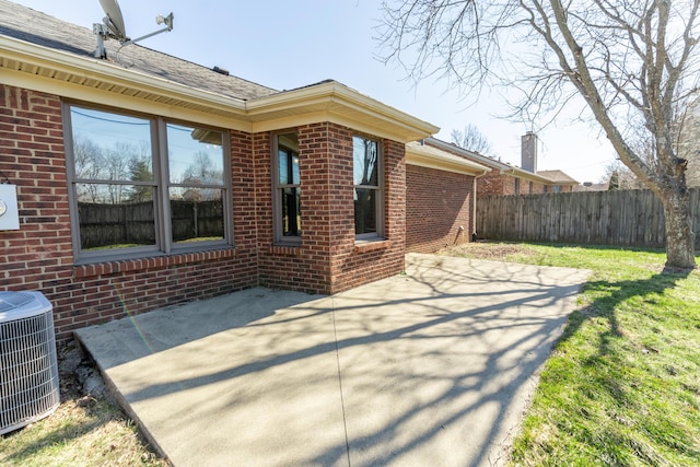 view of patio featuring central AC unit and fence