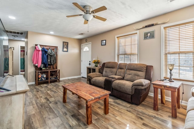 living room featuring hardwood / wood-style floors, a textured ceiling, a wealth of natural light, and ceiling fan