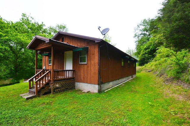 view of side of home featuring a yard