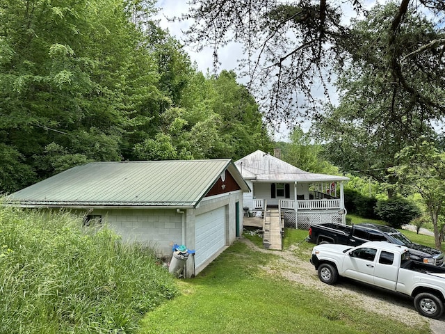 exterior space featuring a garage and a lawn