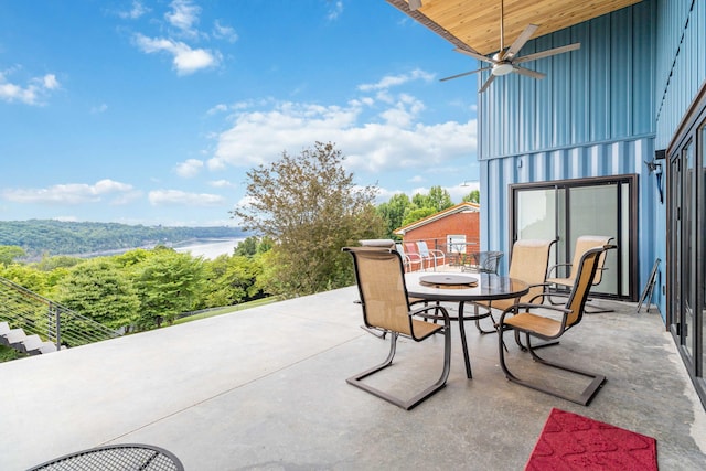 view of patio featuring ceiling fan and a water view