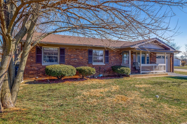 ranch-style house featuring a garage, brick siding, a front lawn, and covered porch