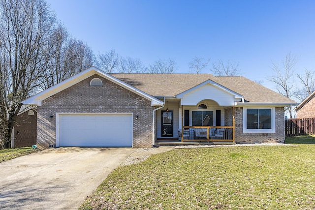 ranch-style house featuring a porch, a garage, and a front lawn