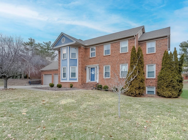 view of front facade with a front lawn, brick siding, driveway, and an attached garage