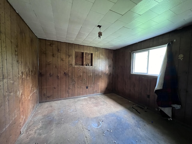 empty room featuring wood walls