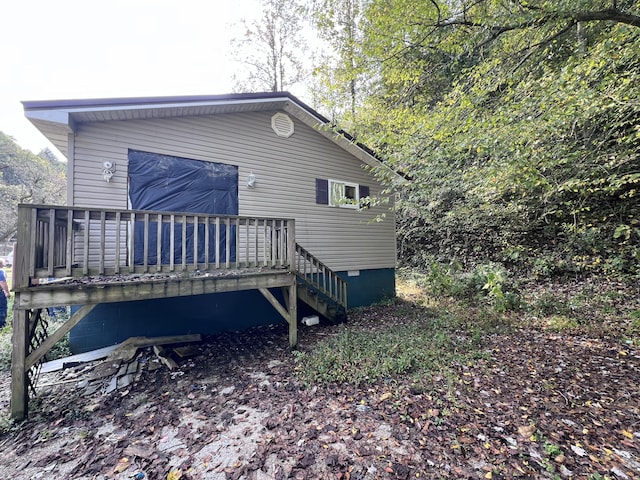 back of property with a wooden deck