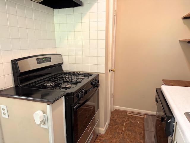 kitchen featuring range with gas cooktop, visible vents, baseboards, exhaust hood, and decorative backsplash