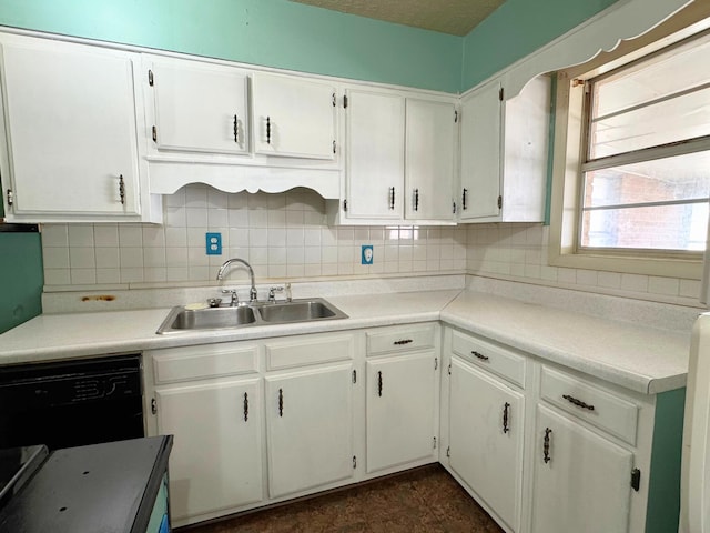 kitchen with sink, tasteful backsplash, white cabinets, and black dishwasher