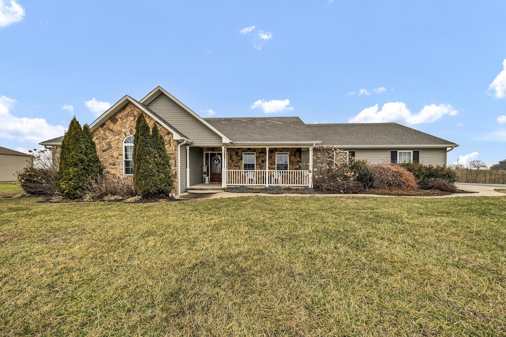 single story home with a porch and a front yard