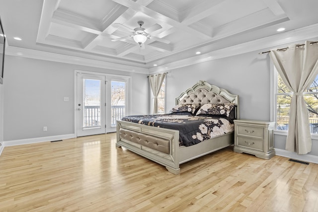 bedroom with multiple windows, access to outside, light hardwood / wood-style floors, and beam ceiling