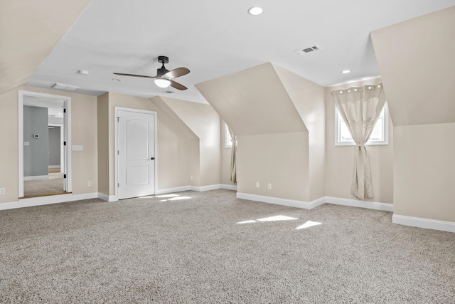 additional living space with lofted ceiling, ceiling fan, and carpet flooring