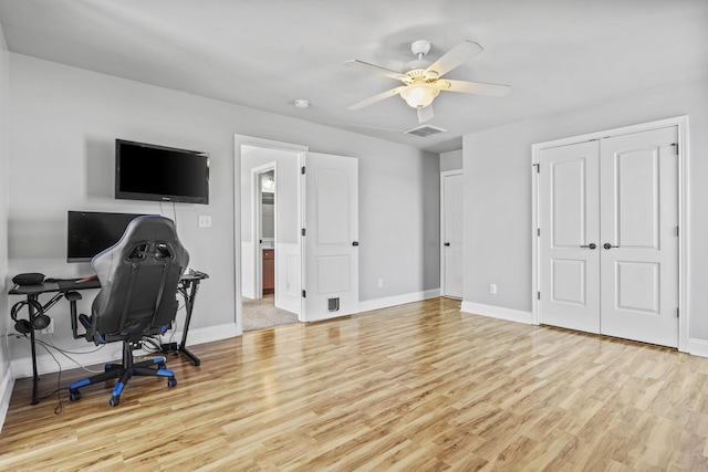 office with ceiling fan and light hardwood / wood-style floors