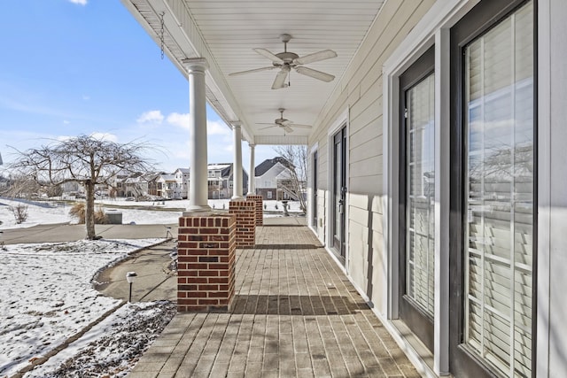 snow covered patio featuring ceiling fan