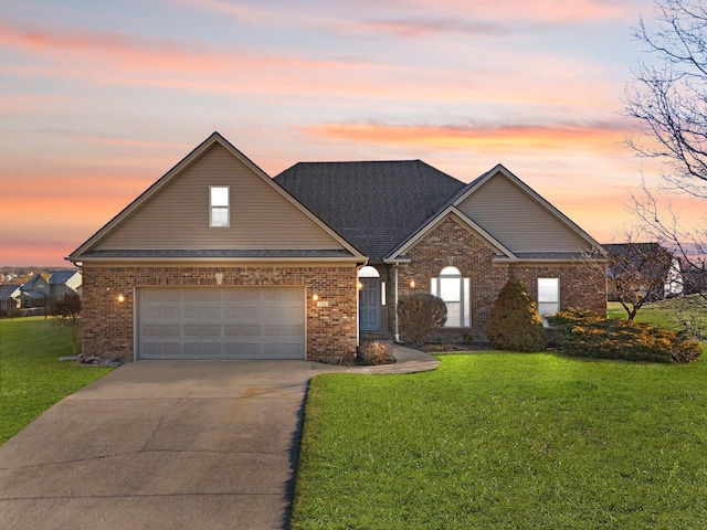 view of front facade with an attached garage, a front lawn, concrete driveway, and brick siding