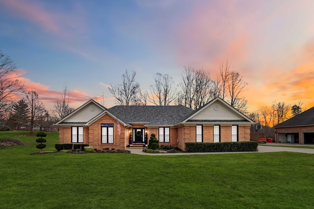 ranch-style home with a lawn