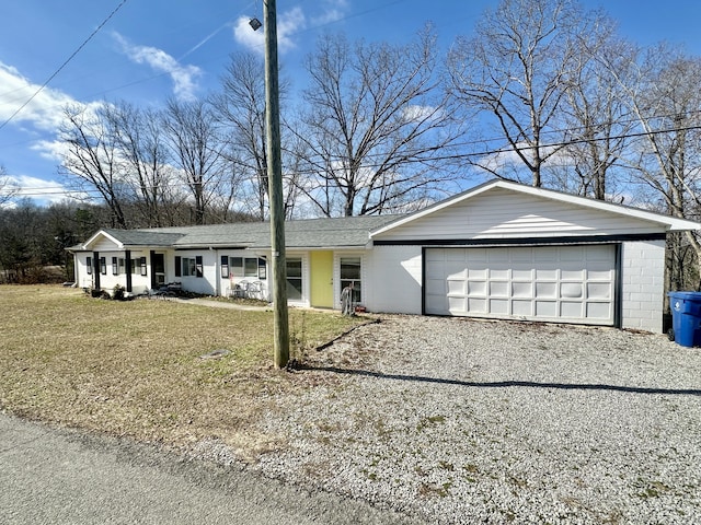 ranch-style house featuring a garage and a front yard