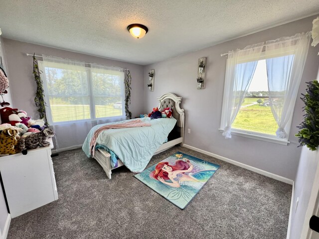 carpeted bedroom with baseboards and a textured ceiling