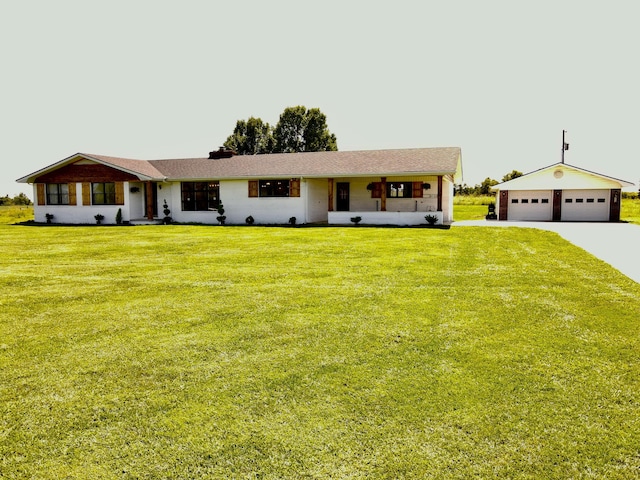 view of front of home featuring a front lawn, a chimney, an outdoor structure, and a garage