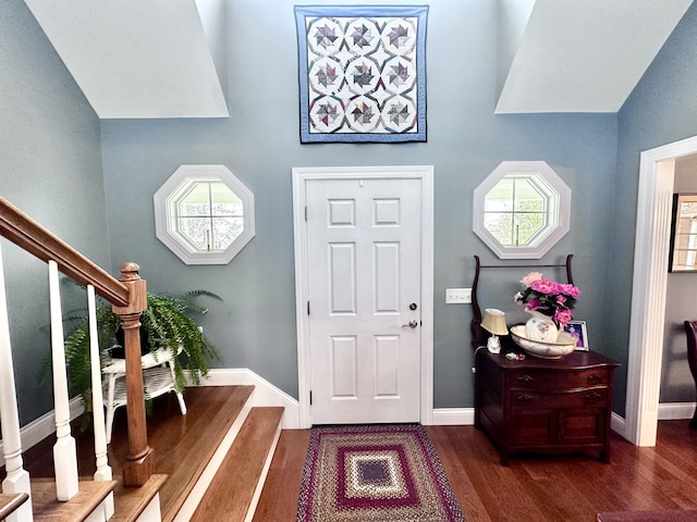 entrance foyer featuring stairs, dark wood-style flooring, and baseboards