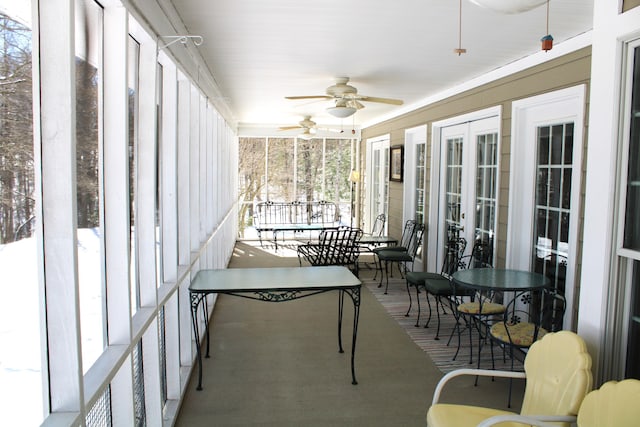 sunroom with french doors and a ceiling fan